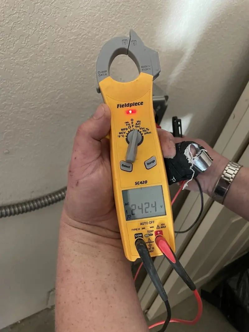Voltage testing with clamp meter during Recessed Lighting Installation in Ovilla
